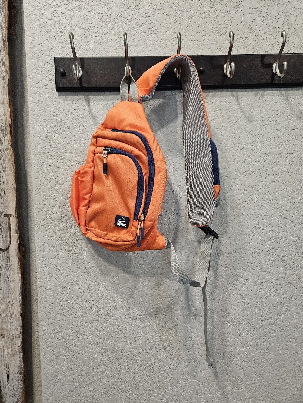 Apex Orange Sling Backpack with Gray Strap and Navy Accents